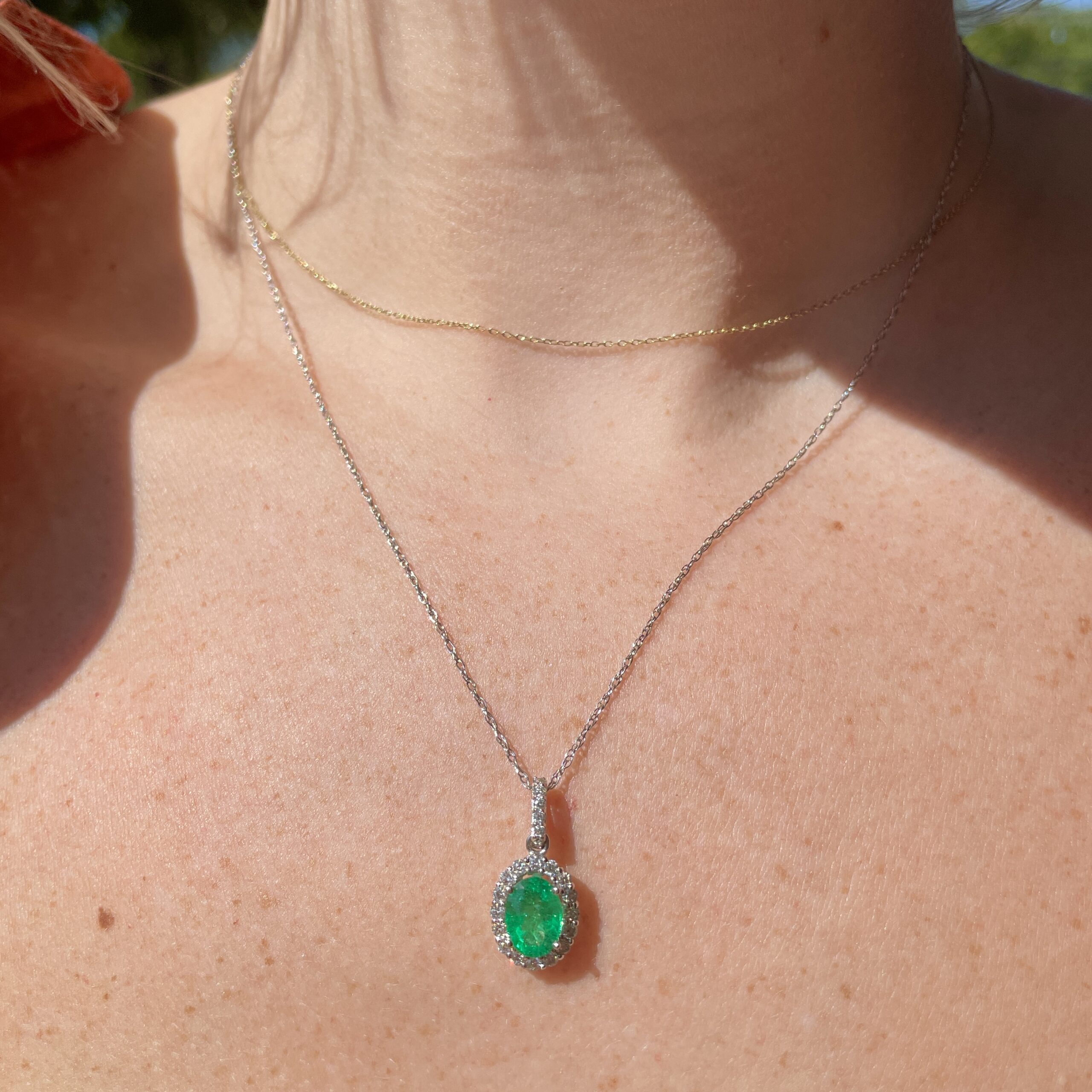 White Gold Emerald and Diamond Oval Halo Necklace